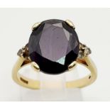 A Vintage 9K Yellow Gold Amethyst Ring. Dark faceted oval amethyst on a crown setting with small