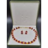 A sophisticated, Chinese, necklace and earrings set with large ruby cabochons (12 mm) and 18 K