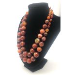 A 1200ct Two-Row Graduated Fire Autumn Agate Bead Necklace. 44cm. 16mm - largest bead.