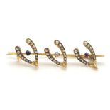 An Antique Victorian 15K Gold (tested) Brooch. Three wishbone design with Diamond, Sapphire, Ruby