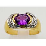 An 18K Yellow Gold Amethyst and Diamond Ring. Central clean amethyst surrounded by two arcs of