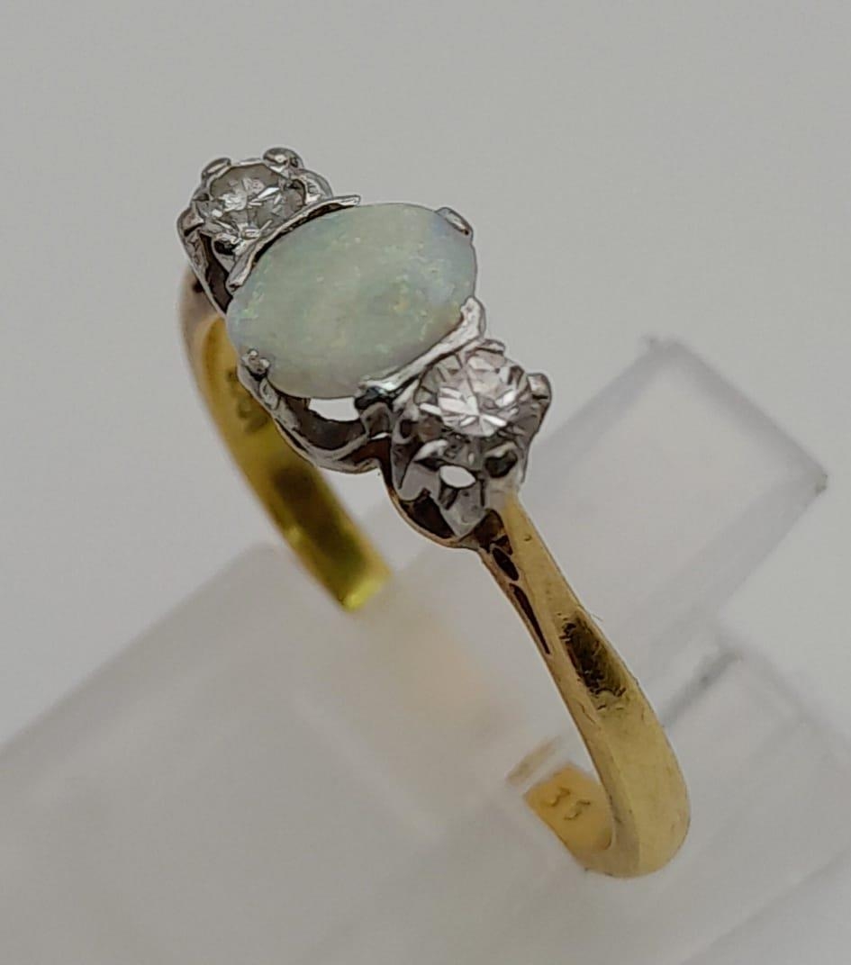 An 18 K yellow gold ring with an opal cabochon and two brilliant cut diamonds. Ring size: L, weight: - Image 2 of 4