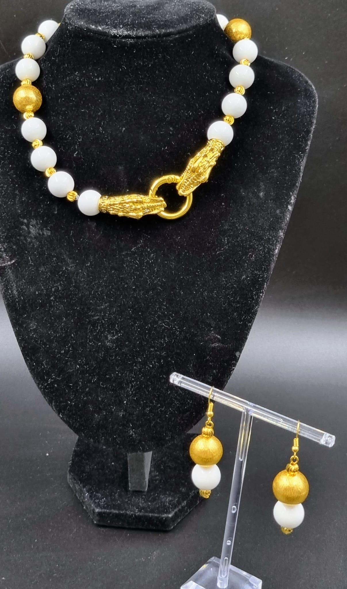 An unusual, Chinese, white jade necklace and earrings set with an 18 K yellow gold plated twin