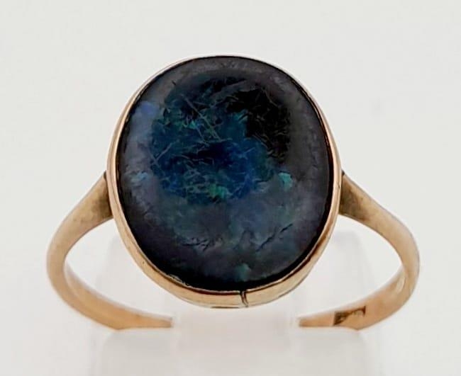 A Vintage 9K Yellow Gold Australian Black Opal Ring. Size O. 2g total weight.