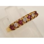 An 18K Yellow Gold Ruby and Diamond Ring. Seven stones. Size I. 2.27g