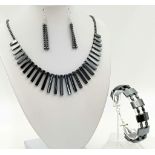 A beautiful, modern necklace, bracelet and earrings set made of highly polished haematite. In a