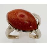 A 925 Silver Cross-Back Ring with Goldstone. Size Q. 7.08g.