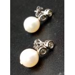 A Pair of 14K Gold, Pearl and Diamond Earrings. 0.20ct. Natural pearls. 2.21g total weight.