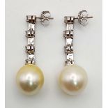 A Pair of 18K White Gold and Diamond Natural South Sea Pearl Drop Earrings. 12mm pearl. 2ct