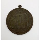 An Early Noori Allah Metal Pendant with Quran Scripture on Reverse. 5cm diameter.