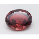 A gorgeous, large (116 carats) ZIRCON. Oval cut, flawless, in a vivid, smoky red/orange colour. This