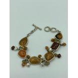 SILVER BRACELET set with polished Agate stones and semi precious stone detail. T-bar fastening.