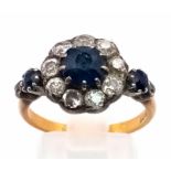 A Vintage 18K Yellow Gold Diamond and Sapphire Ring. Central sapphire surrounded by a halo of 10