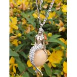 A VERY RARE MELO PEARL OF APPROX 140cts SET IN A 18K WHITE GOLD PENDANT IN THE FORM OF A MERMAID