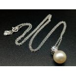 An 18K White Gold and Natural Pearl Pendant on a 9K White Gold Disappearing Necklace. 12mm