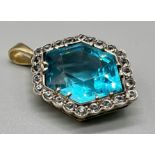 A Large Blue Hexagonal Zircon with White Sapphires on a 14K Gold Pendant. 3.5cm. 9.72g total weight.