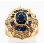 An 18K Gold Diamond and Sapphire Ring. Large centre sapphire surrounded by smaller baguette