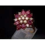 A STUNNING 18K GOLD RUBY AND DIAMOND CLUSTER RING WITH TOP QUALITY STONES. 5.3gms size M