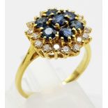AN 18K GOLD SAPPHIRE AND DIAMOND CLUSTER RING. 4.6gms size O/P