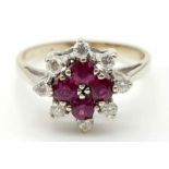 AN 18K WHITE GOLD RUBY AND DIAMOND CLUSTER RING. 4.15gms size P