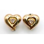 A Pair of 18K Yellow Gold Diamond Heart Earrings. Two heart-shaped diamonds within a gold heart-