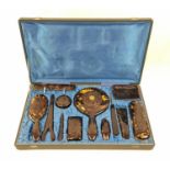 An Antique Ladies Tortoise shell grooming set in a satin lined vanity case. Very good condition.