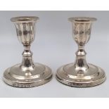 A pair of Georgian Solid Silver Candle Holders of an unusual size. 10.5cm in height and weighs 393.