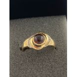 9 carat GOLD RING having GARNET CABOCHON set to top in circular Gold mount. Full UK hallmark. 2.91