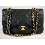 A Medium Classic Double Chanel Flap Bag. Black lambskin leather with 24K gold plated hardware.