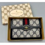 A Used Gucci Monogramed Purse. 15 x 10cm.