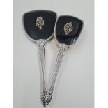 A Vintage Silver-Plate Hand Mirror and Hair Brush. Black back with ornate decoration. Mirror-