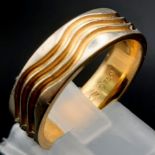 An 18K Yellow and White Gold Wave Decorative Band Ring. Size O. 8.2g.