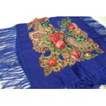 A blue floral piano square shawl with tasselled edging. 110cm x 100cm