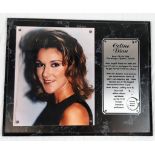 A Celine Dion Picture (circa 1990s) and an Informative Plaque. On wood base - 39 x 31cm.