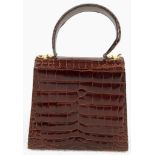 An Italian Salvatore Ferragamo Crocodile Bag. Finished in chocolate brown with gilded touches and