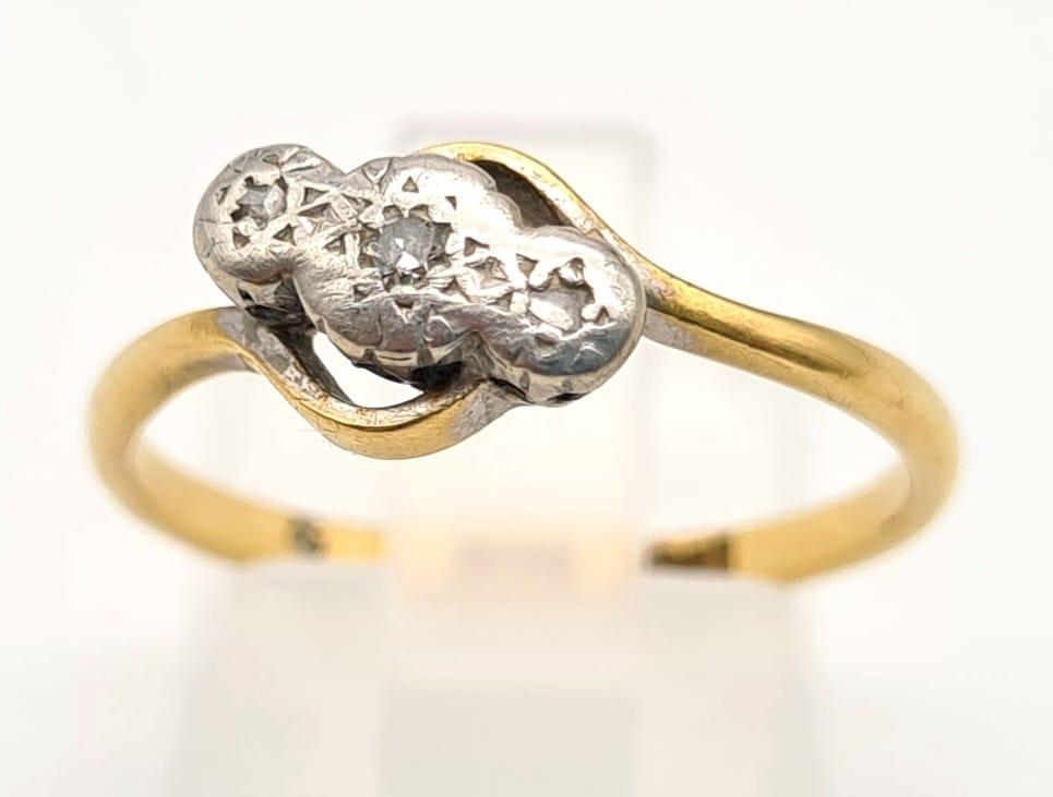 An 18K Yellow Gold Three-Stone Diamond Ring. Size P. 2.7g