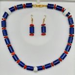 A substantial lapis lazuli and red coral necklace and earrings set in a presentation box. Necklace