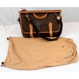 A Louis Vuitton Monogram Canvas Luggage Satchel. This extra large bag has two carrying methods -