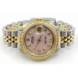 LADIES ROLEX OYSTER PERPETUAL DATEJUST WITH DIAMOND BEZEL AND NUMERALS AND PINK FACE. Come with