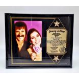 A Sonny and Cher Picture (1970s) and an Informative Plaque. In frame - 25 x 21cm.