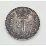 An 1878 Silver Four Pence Coin. Near Uncirculated. Obverse - Bare head of Queen Victoria facing