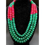 A Vivid 100ct Three-Strand Ruby and Emerald Bead Necklace. Beads - 10mm. 46cm.