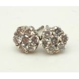 A Pair of 18K White Gold and Diamond Stud Earrings. 14 diamonds in total - 0.40ct. 1.20g total