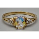 A 9K Yellow Gold ring with Centre Iridescent Stone with Diamonds on both sides. Size O/P.