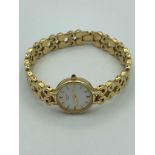 Ladies gold plated ROTARY quartz wristwatch, having circular white face with golden digits and