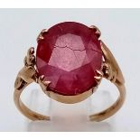 A 9K Yellow Gold Ruby Ring. Large faceted centre stone. Size K. 2.92g total weight.