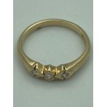 9 carat GOLD and DIAMOND RING, having three diamonds individually set to top in geometric mounts.