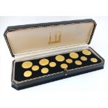 A Selection of 14 Dunhill Gilded Dress Buttons. Comes in original Dunhill case.