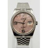 A ROLEX OYSTER PERPETUAL DATEJUST WITH UNUSUAL PINK FLORAL DIAL AND DIAMOND BEZEL. COMES WITH