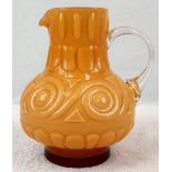 AN EARLY ITALIAN PATTERNED GLASS JUG IN AN UNUSUAL MUSTARD COLOUR. 22cms tall